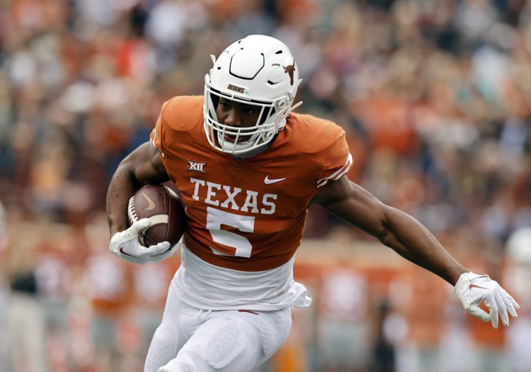 Bijan Robinson running the football for the Texas Longhorns during a college game, symbolizing Campus 2 Canton league college-to-NFL journey
